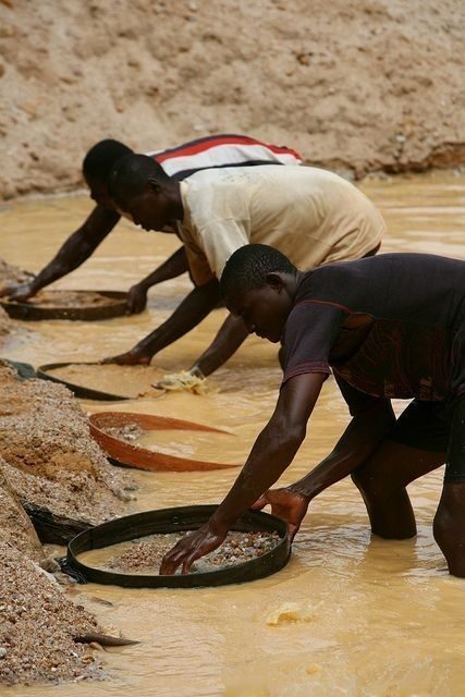 Miners panning for gold in a river